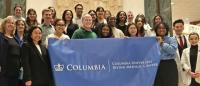 Group of students from CUIMC holding a banner at Albany gathering